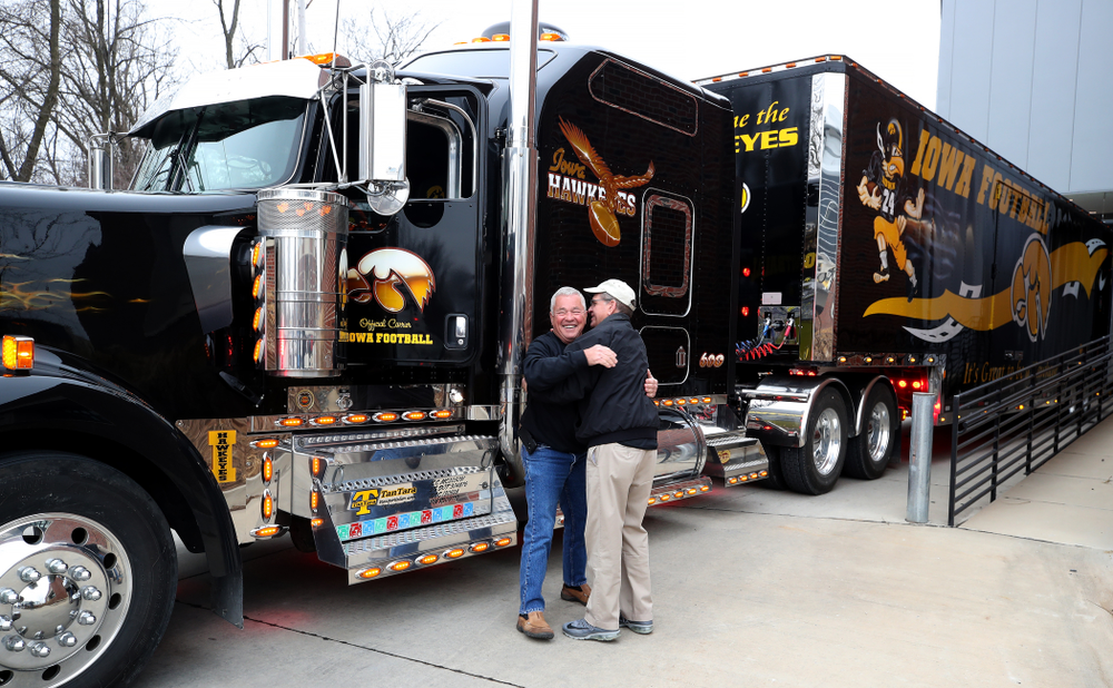 TanTara Transportation Corporation President Mike Riggan hugs head football equipment manager Greg Morris before departing for Tampa Florida Friday, December 21, 2018 at the Hansen Football Performance Center. (Brian Ray/hawkeyesports.com)