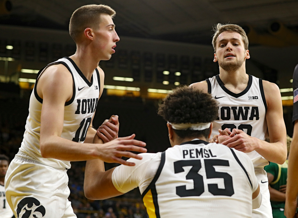 Iowa Hawkeyes guard Joe Wieskamp (10) and forward Riley Till (20) help up forward Cordell Pemsl (35) after he was fouled during the second half of their game at Carver-Hawkeye Arena in Iowa City on Sunday, Nov 24, 2019. (Stephen Mally/hawkeyesports.com)
