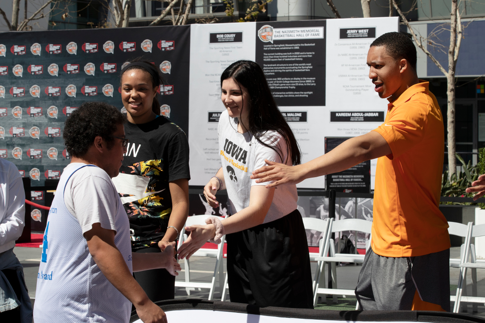 Iowa Hawkeyes forward Megan Gustafson (10) and TennesseeÕs Grant Williams slap hands with the athletes following a Special Olympics Event Friday, April 12, 2019 in the XBOX Plaza at LA Live. (Brian Ray/hawkeyesports.com)