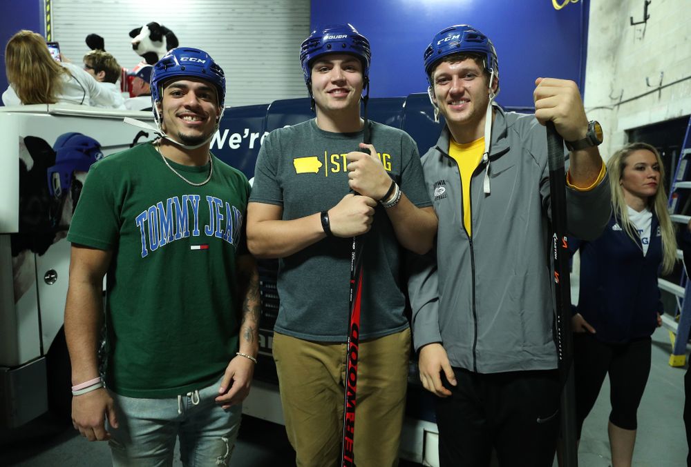 Iowa Hawkeyes tight end T.J. Hockenson (38), quarterback Nate Stanley (4), and defensive back Amani Hooker (27) before an on ice contest against Mississippi State during the first intermission of the Tampa Bay Lightning game Thursday, December 27, 2018 at Amalie Arena. (Brian Ray/hawkeyesports.com)
