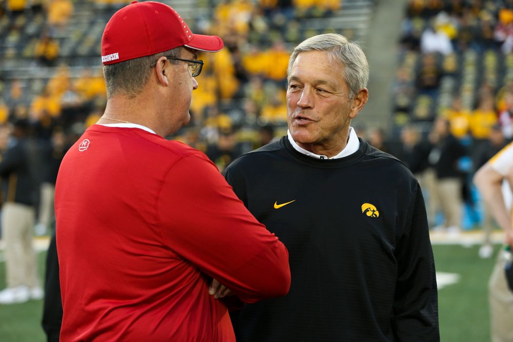 Iowa Hawkeyes head coach Kirk Ferentz meets with Wisconsin Badgers head coach Paul Chryst before a game against Wisconsin at Kinnick Stadium on September 22, 2018. (Tork Mason/hawkeyesports.com)