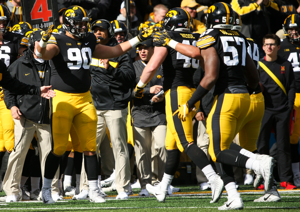 Iowa Hawkeyes defensive end Sam Brincks (90) greets Iowa Hawkeyes defensive end Parker Hesse (40) after Hesse's sack during a game against Maryland at Kinnick Stadium on October 20, 2018. (Tork Mason/hawkeyesports.com)