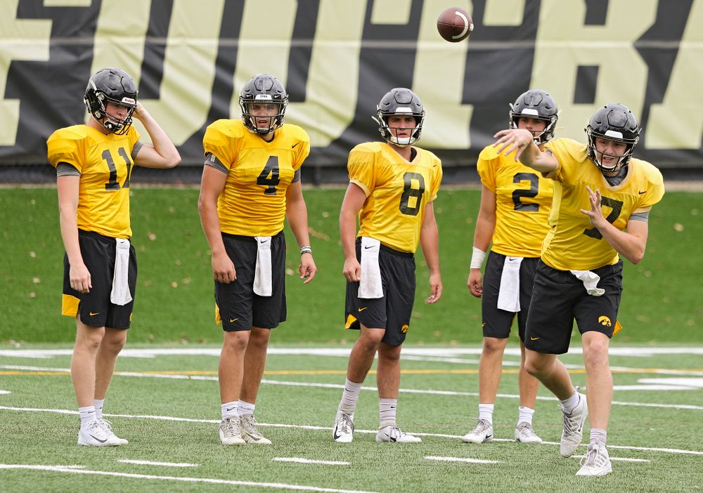 Iowa Hawkeyes quarterback Spencer Petras (7) throws a pass as quarterback Connor Kapisak (11), quarterback Nate Stanley (4), quarterback Alex Padilla (8), and quarterback Peyton Mansell (2) look on during Fall Camp Practice No. 15 at the Hansen Football Performance Center in Iowa City on Monday, Aug 19, 2019. (Stephen Mally/hawkeyesports.com)