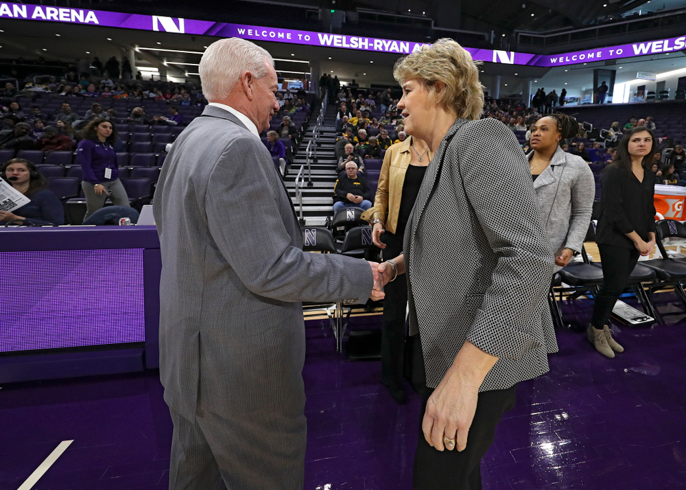 Northwestern Wildcats head coach Joe McKeown shakes hands with Iowa Hawkeyes head coach Lisa Bluder before their game at Welsh-Ryan Arena in Evanston, Ill. on Sunday, January 5, 2020. (Stephen Mally/hawkeyesports.com)
