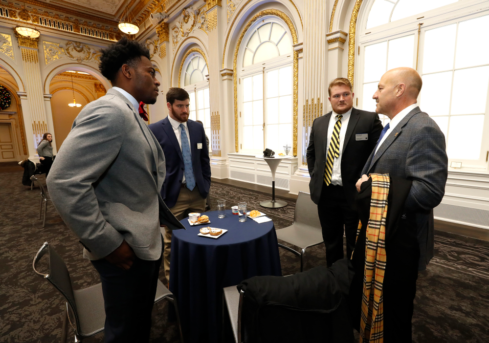 Iowa Hawkeyes linebacker Josey Jewell (43), defensive back Joshua Jackson (15), offensive lineman Sean Welsh (79) and head coach Kirk Ferentz ring the opening bell at the New York Stock Exchange Tuesday, December 26, 2017 in New York. (Brian Ray/hawkeyesports.com)