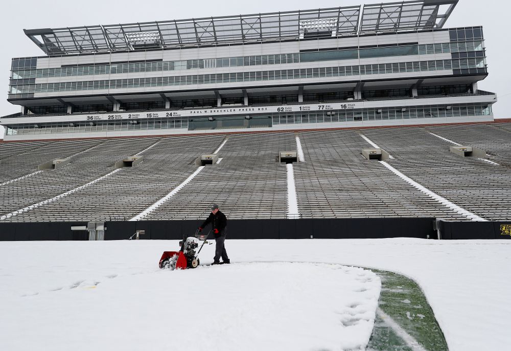 Members of the Iowa Athletics Turf Management staff create the #SnowWave for kids in the Stead Family Children's Hospital Thursday, February