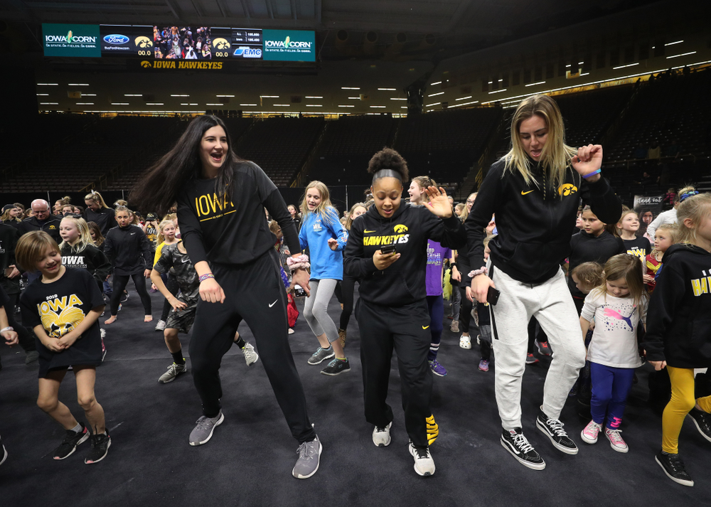 Iowa Women's Basketball seniors Megan Gustafson, Tania Davis, and forward Hannah Stewart (21) present the awards and dance the Cha Cha Slide following the Gymhawks meet against Illinois Saturday, February 16, 2019 at Carver-Hawkeye Arena. (Brian Ray/hawkeyesports.com)