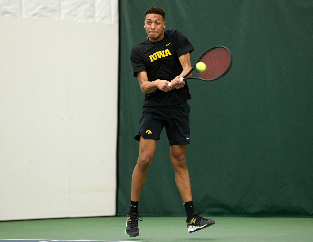 Iowa’s Oliver Okonkwo returns a shot during his singles match at the Hawkeye Tennis and Recreation Complex in Iowa City on Friday, February 14, 2020. (Stephen Mally/hawkeyesports.com)