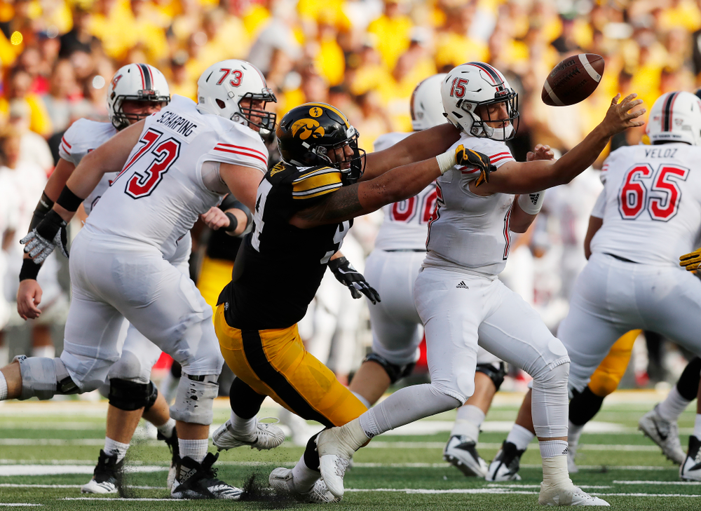 Iowa Hawkeyes defensive end A.J. Epenesa (94) knocks the ball away from Northern Illinois Huskies quarterback Marcus Childers (15) Saturday, September 1, 2018 at Kinnick Stadium. (Brian Ray/hawkeyesports.com)