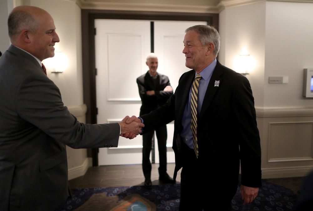 Iowa Hawkeyes head coach Kirk Ferentz shakes hands with USC head coach Clay Helton during a press conference leading up to the Holiday Bowl Thursday, December 26, 2019 in San Diego. (Brian Ray/hawkeyesports.com)