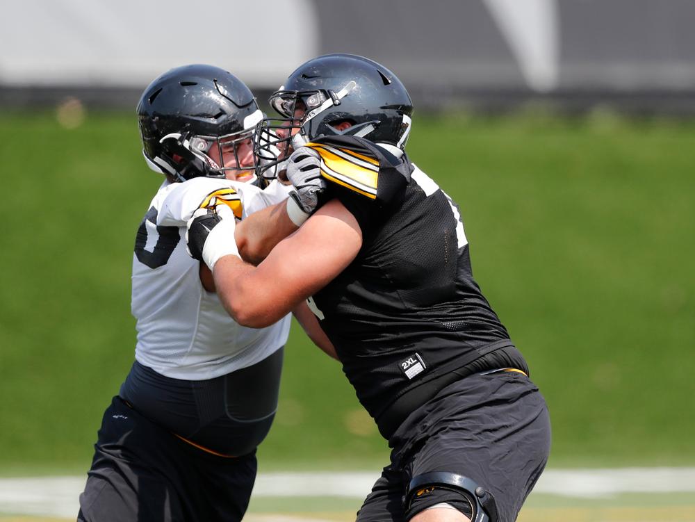 Iowa Hawkeyes offensive lineman Dalton Ferguson (76) and defensive end Sam Brincks (90) during fall camp practice No. 9 Friday, August 10, 2018 at the Kenyon Practice Facility. (Brian Ray/hawkeyesports.com)