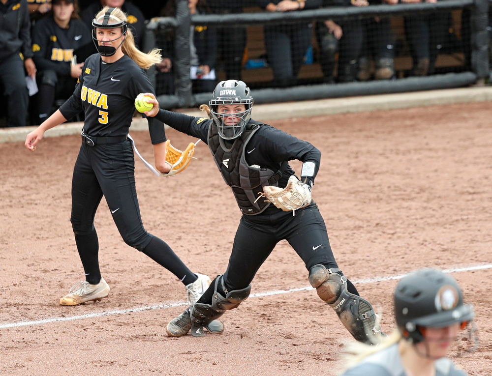 Iowa catcher Abby Lien (9) throws to first base for an out as pitcher Allison Doocy (3) looks on during the fifth inning of their game against Iowa Softball vs Indian Hills Community College at Pearl Field in Iowa City on Sunday, Oct 6, 2019. (Stephen Mally/hawkeyesports.com)