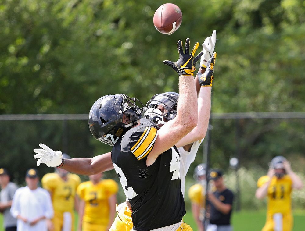 Iowa Hawkeyes tight end Shaun Beyer (42) pulls in a pass over the hands of defensive back Michael Ojemudia (11) during Fall Camp Practice #5 at the Hansen Football Performance Center in Iowa City on Tuesday, Aug 6, 2019. (Stephen Mally/hawkeyesports.com)