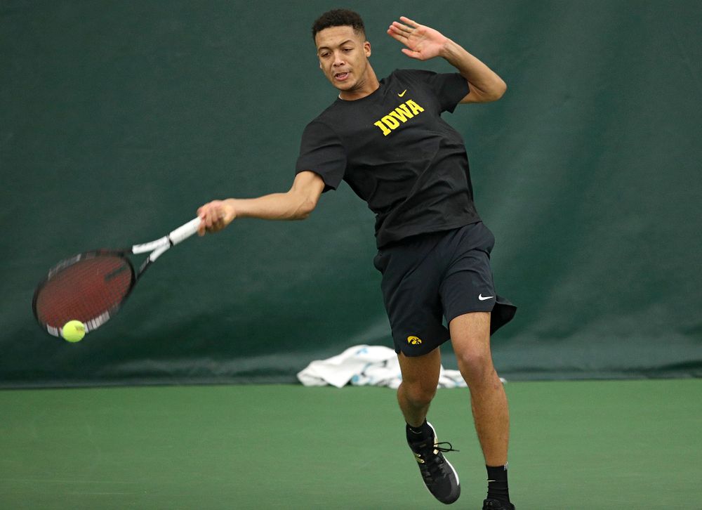 Iowa’s Oliver Okonkwo returns a shot during their match at the Hawkeye Tennis and Recreation Complex in Iowa City on Thursday, January 16, 2020. (Stephen Mally/hawkeyesports.com)