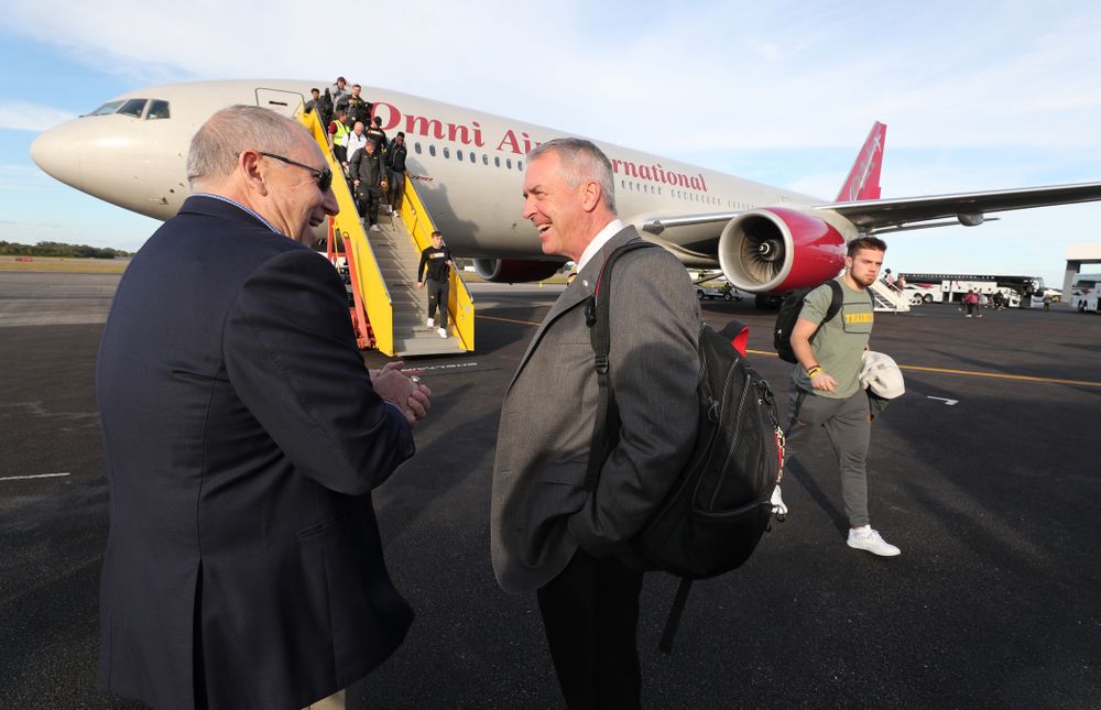Henry B. and Patricia B. Tippie Director of Athletics Chair Gary Barta talks with Outback Bowl team host Bruce Poli Wednesday, December 26, 2018 as the Iowa Hawkeyes arrive in Tampa, Florida for the Outback Bowl. (Brian Ray/hawkeyesports.com)