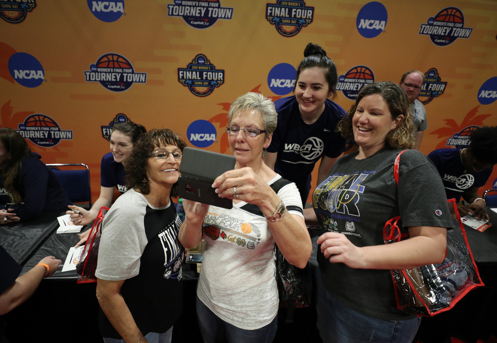 Iowa Hawkeyes forward Megan Gustafson (10) signs autographs with the other WBCA All Americans at the Tourney Town Fan Fest Friday, April 5, 2019 at the Tampa Convention Center in Tampa, FL. (Brian Ray/hawkeyesports.com)