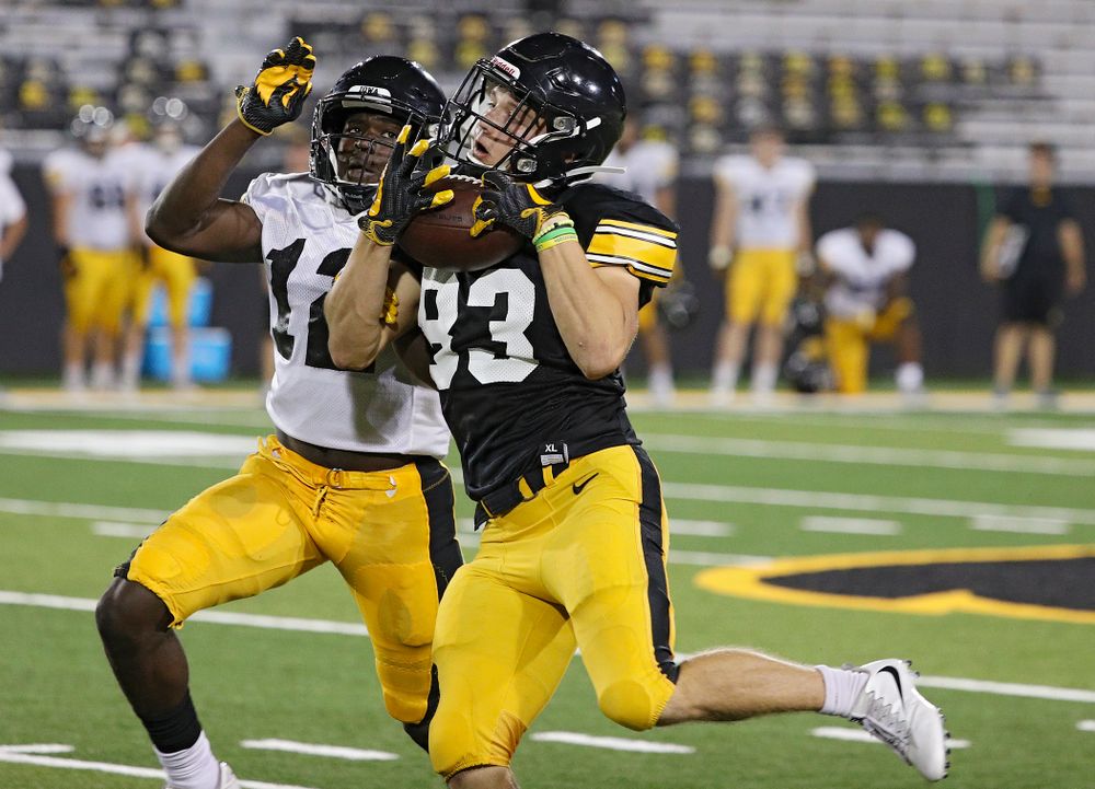 Iowa Hawkeyes wide receiver Alec Kritta (83) pulls in a pass around defensive back D.J. Johnson (12) during Fall Camp Practice No. 12 at Kinnick Stadium in Iowa City on Thursday, Aug 15, 2019. (Stephen Mally/hawkeyesports.com)