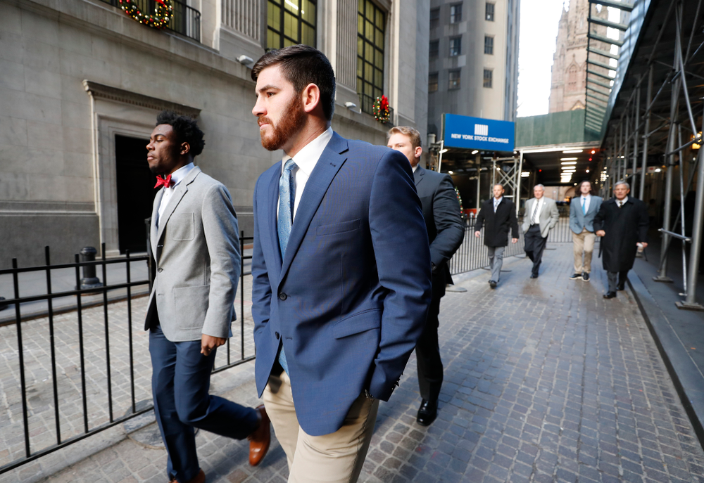 Iowa Hawkeyes linebacker Josey Jewell (43), defensive back Joshua Jackson (15), offensive lineman Sean Welsh (79) and head coach Kirk Ferentz ring the opening bell at the New York Stock Exchange Tuesday, December 26, 2017 in New York. (Brian Ray/hawkeyesports.com)