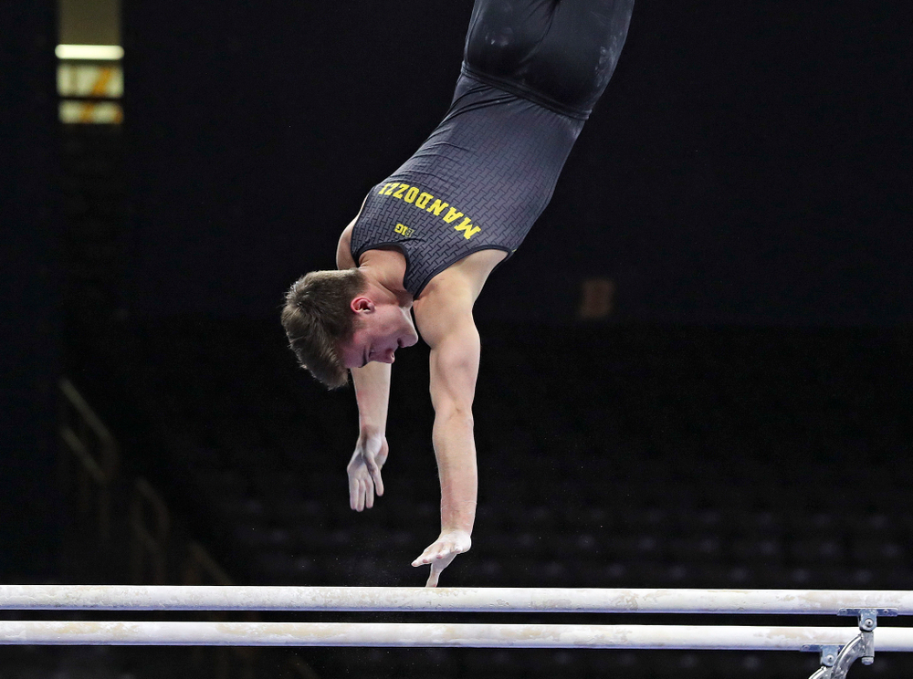 Iowa's Mitch Mandozzi competes in the parallel bars during the first day of the Big Ten Men's Gymnastics Championships at Carver-Hawkeye Arena in Iowa City on Friday, Apr. 5, 2019. (Stephen Mally/hawkeyesports.com)