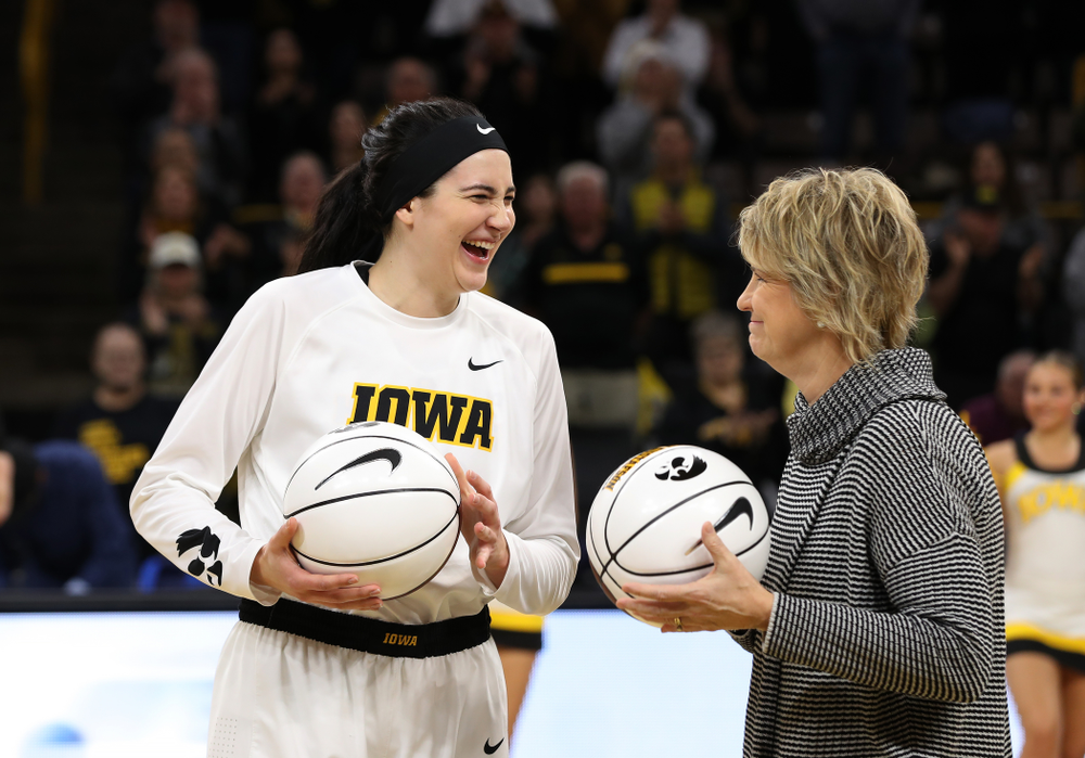 Iowa Hawkeyes forward Megan Gustafson (10) receives a pair of commemorative basketballs from head coach Lisa Bluder for becoming the school's all time rebounds leader and scoring leader before their gam eagainst the Nebraska Cornhuskers Thursday, January 3, 2019 at Carver-Hawkeye Arena. (Brian Ray/hawkeyesports.com)