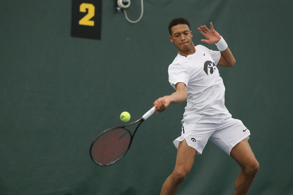 Iowa’s Oliver Okonkwo returns a hit during the Iowa men’s tennis meet vs Nebraska on Sunday, March 1, 2020 at the Hawkeye Tennis and Recreation Complex. (Lily Smith/hawkeyesports.com)