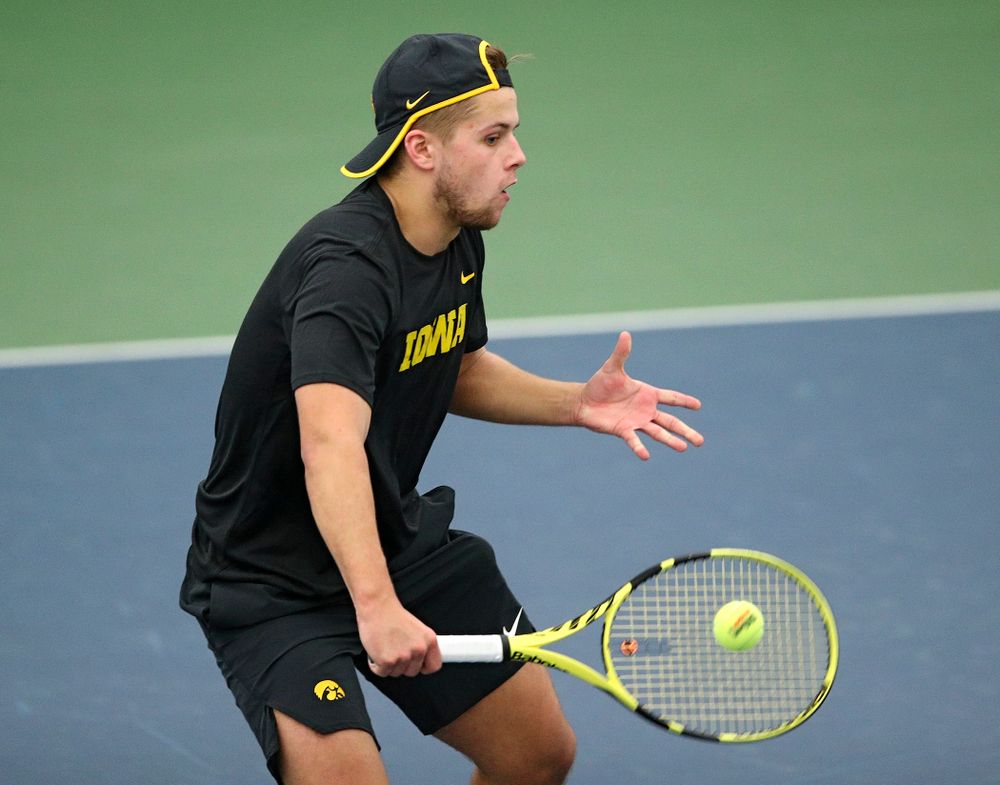 Iowa’s Will Davies returns a shot during their match at the Hawkeye Tennis and Recreation Complex in Iowa City on Thursday, January 16, 2020. (Stephen Mally/hawkeyesports.com)