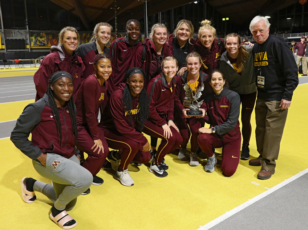 Larry Wieczorek hands out the women’s team award to Minnesota during the Larry Wieczorek Invitational at the Recreation Building in Iowa City on Saturday, January 18, 2020. (Stephen Mally/hawkeyesports.com)