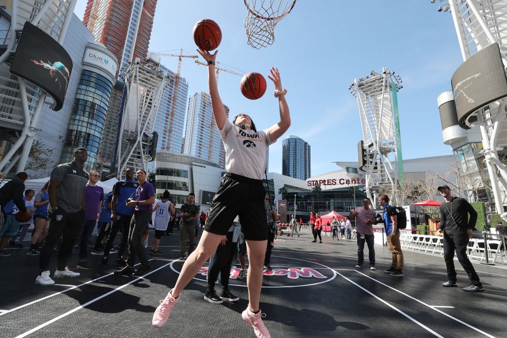 Iowa Hawkeyes forward Megan Gustafson (10) does the Mikan drill as DukeÕs Zion Williamson and RJ Barrett look on during a Special Olympics event Friday, April 12, 2019 as part of the ESPN College Basketball Awards in the XBOX Plaza at LA Live. (Brian Ray/hawkeyesports.com)