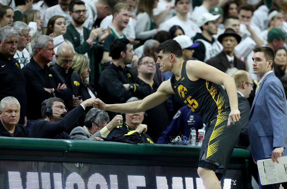 Iowa Hawkeyes forward Luka Garza (55) fist bumps Bobby Hansen against Michigan State Tuesday, February 25, 2020 at the Breslin Center in East Lansing, MI. (Brian Ray/hawkeyesports.com)