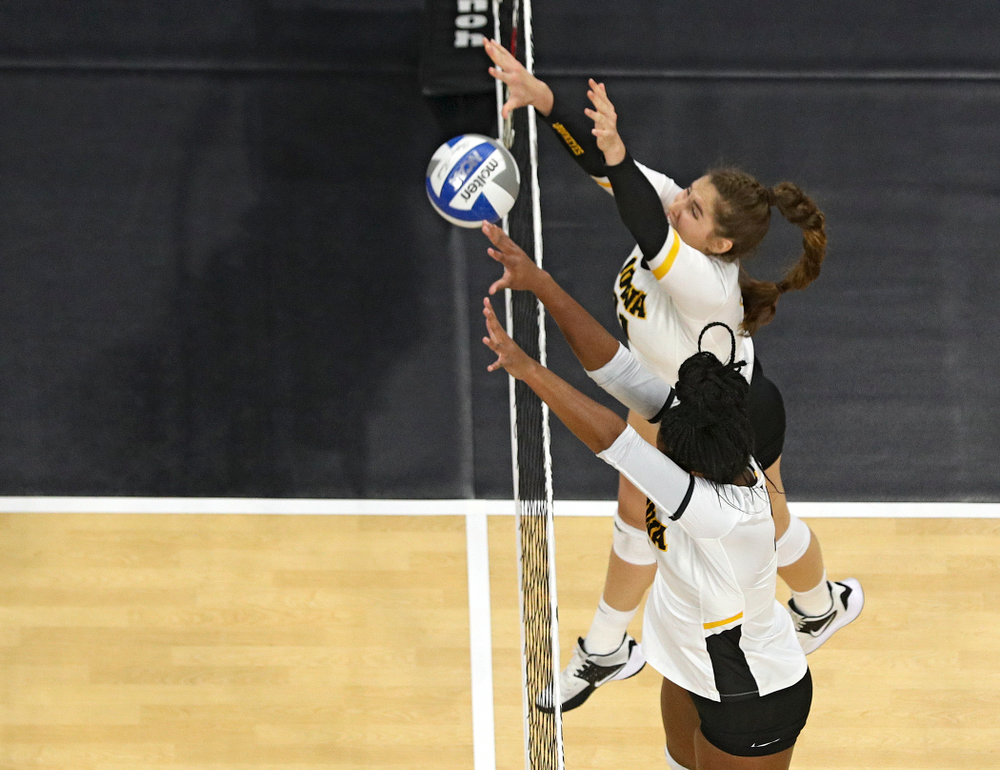 Iowa’s Blythe Rients (top) and Amiya Jones (9) get up for a block during the second set of their match at Carver-Hawkeye Arena in Iowa City on Saturday, Nov 30, 2019. (Stephen Mally/hawkeyesports.com)