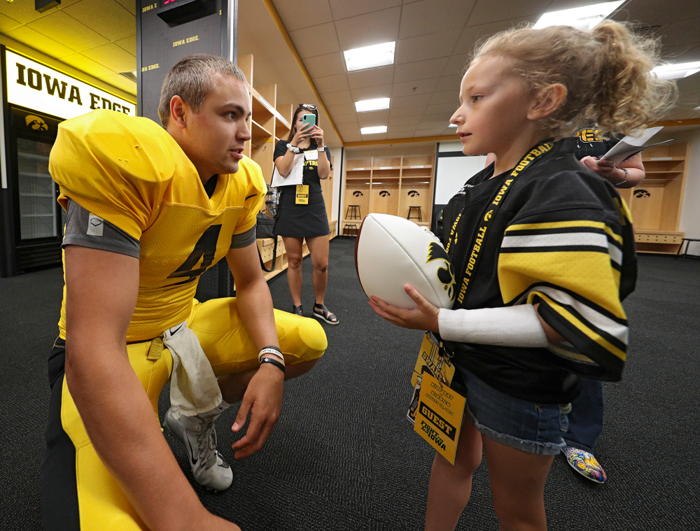 Iowa Hawkeyes quarterback Nate Stanley (4) talks with Kid Captain Charlotte Keller during Kids Day at Kinnick Stadium in Iowa City on Saturday, Aug 10, 2019. (Stephen Mally/hawkeyesports.com)