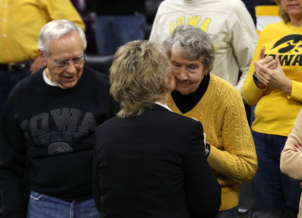 Iowa Hawkeyes head coach Lisa Bluder kisses her mother before their game against the Northwestern Wildcats Sunday, March 3, 2019 at Carver-Hawkeye Arena. (Brian Ray/hawkeyesports.com)