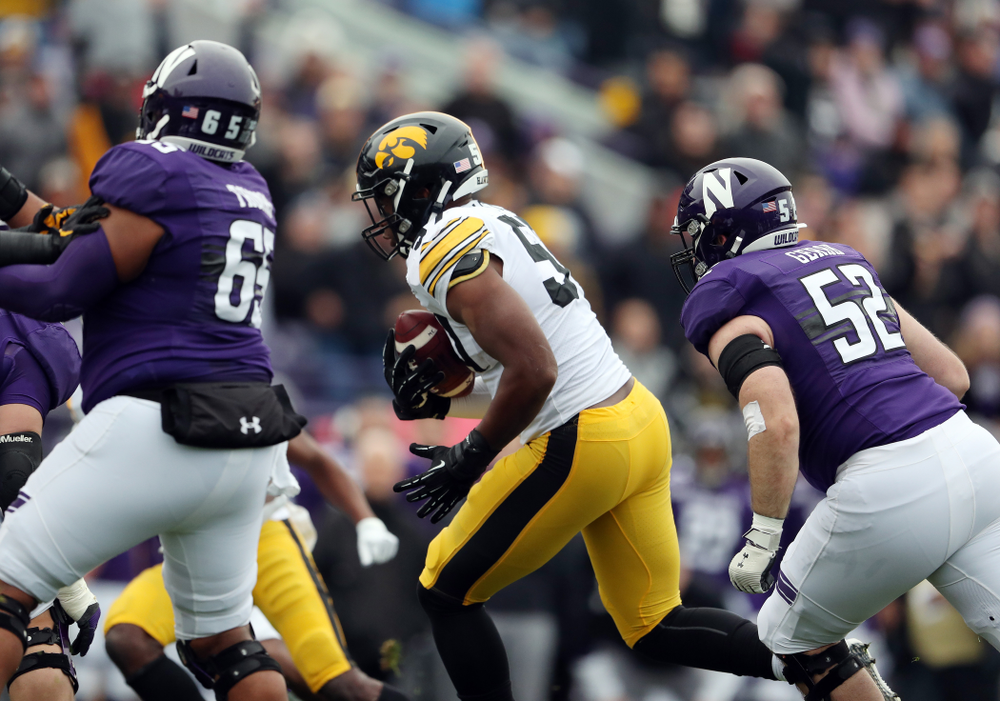 Iowa Hawkeyes defensive end Chauncey Golston (57) intercepts a pass against the Northwestern Wildcats Saturday, October 26, 2019 at Ryan Field in Evanston, Ill. (Brian Ray/hawkeyesports.com)