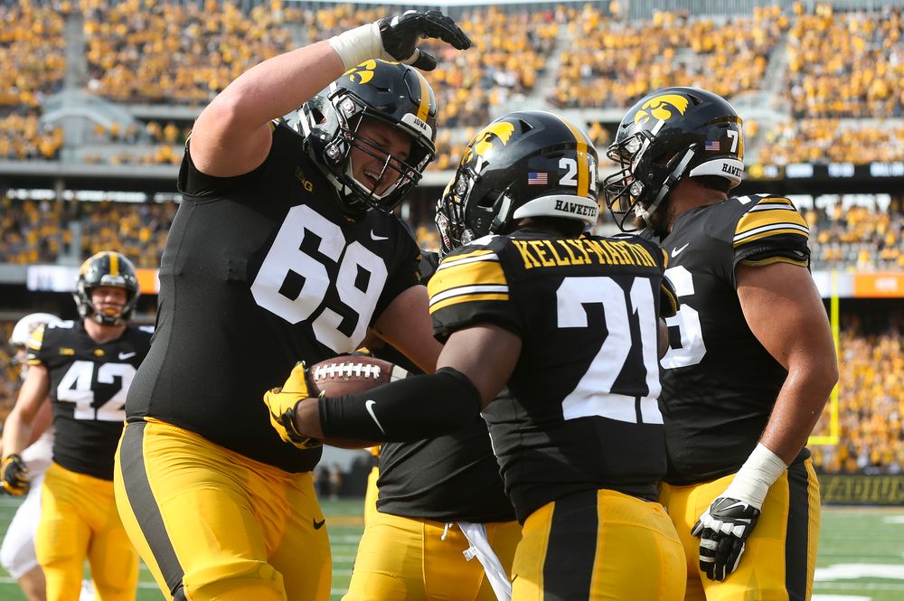 Iowa Hawkeyes offensive lineman Keegan Render (69), Iowa Hawkeyes running back Ivory Kelly-Martin (21)