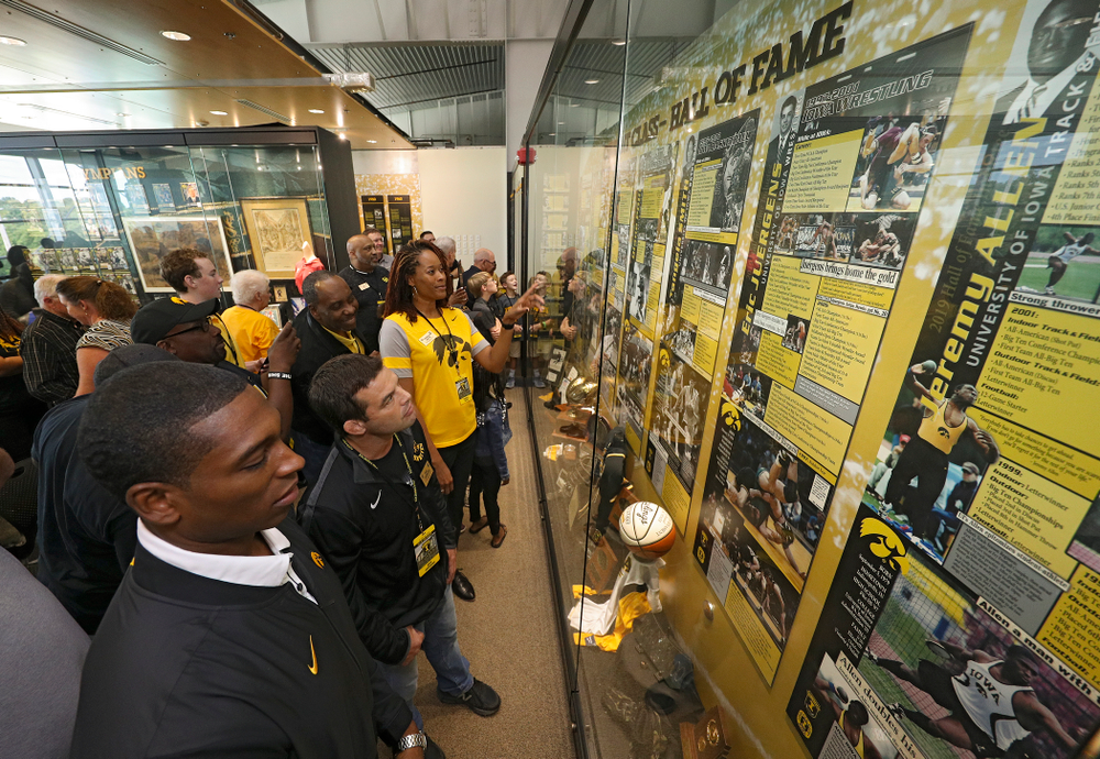 2019 University of Iowa Athletics Hall of Fame inductee Jeremy Allen, Eric Juergens, and Tangela Smith look at their exhibit after it was unveiled at the University of Iowa Athletics Hall of Fame in Iowa City on Friday, Aug 30, 2019. (Stephen Mally/hawkeyesports.com)