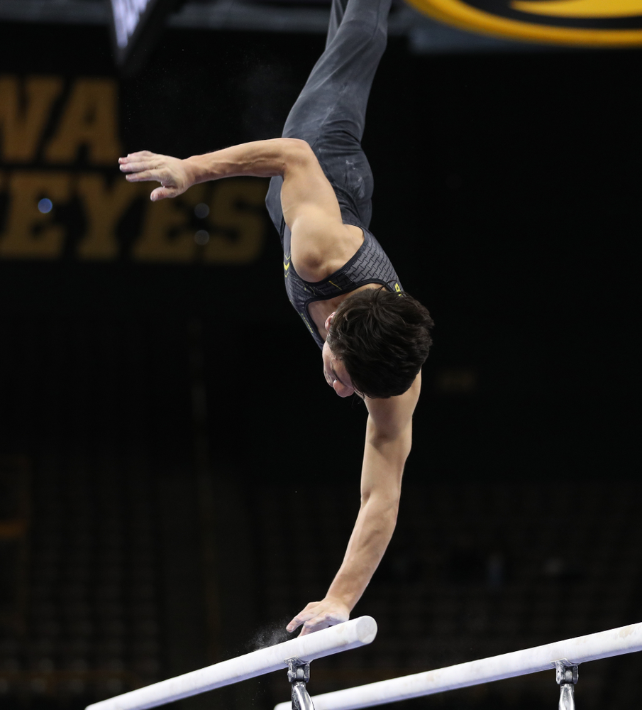 Iowa's Evan Davis competes on the parallel bars against the Ohio State Buckeyes Saturday, March 16, 2019 at Carver-Hawkeye Arena. (Brian Ray/hawkeyesports.com)