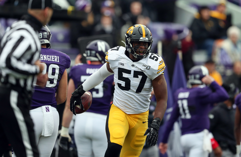 Iowa Hawkeyes defensive end Chauncey Golston (57) celebrates an interception against the Northwestern Wildcats Saturday, October 26, 2019 at Ryan Field in Evanston, Ill. (Brian Ray/hawkeyesports.com)