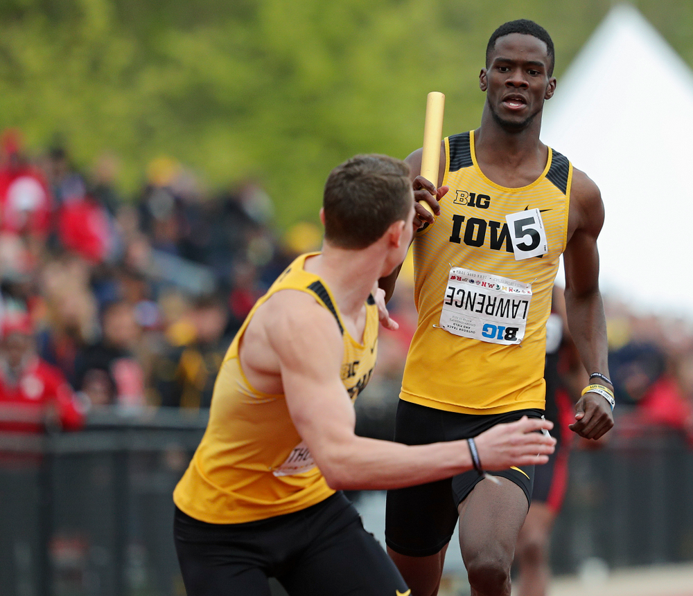 Iowa's Wayne Lawrence Jr. (rights) hands the baton off to Chris Thompson during the 1600 meter relay event on the third day of the Big Ten Outdoor Track and Field Championships at Francis X. Cretzmeyer Track in Iowa City on Sunday, May. 12, 2019. (Stephen Mally/hawkeyesports.com)