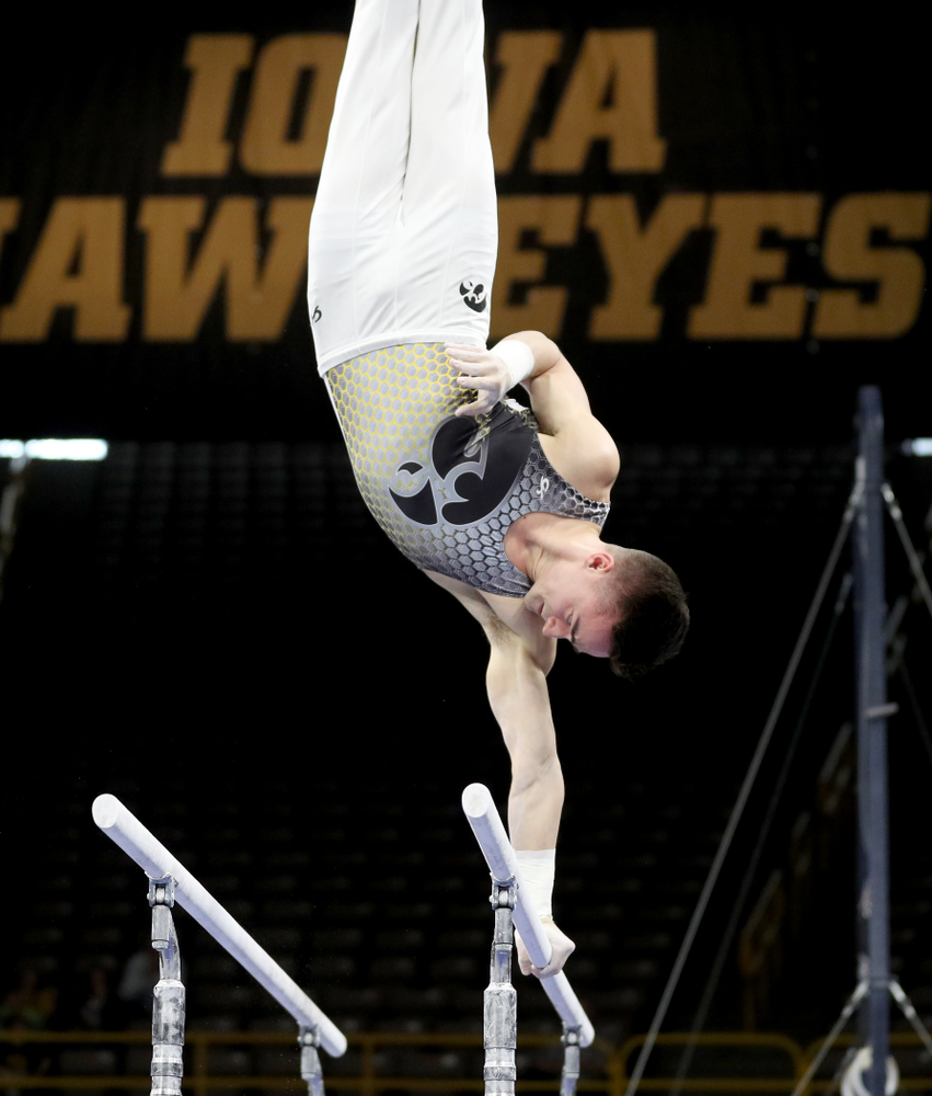 Iowa’s Mitch Mandozzi competes on the parallel bars against Illinois Sunday, March 1, 2020 at Carver-Hawkeye Arena. (Brian Ray/hawkeyesports.com)