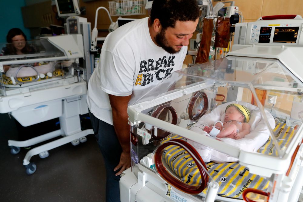 Iowa Hawkeyes offensive lineman Dalton Ferguson (76) and his girlfriend Rachael stand with their newborn twins Ella and Hazel Wednesday, September 12, 2018 in the NICU at the Stead Family Children's Hospital (Brian Ray/hawkeyesports.com)
