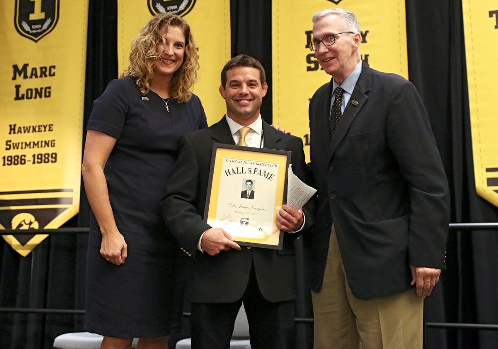 Barb Randall (from left), co-chair of the Varsity Club Advisory Committee, 2019 University of Iowa Athletics Hall of Fame inductee Eric Juergens, and Andy Piro, assistant athletics director and executive director of the Varsity Club, during the Hall of Fame Induction Ceremony at the Coralville Marriott Hotel and Conference Center in Coralville on Friday, Aug 30, 2019. (Stephen Mally/hawkeyesports.com)