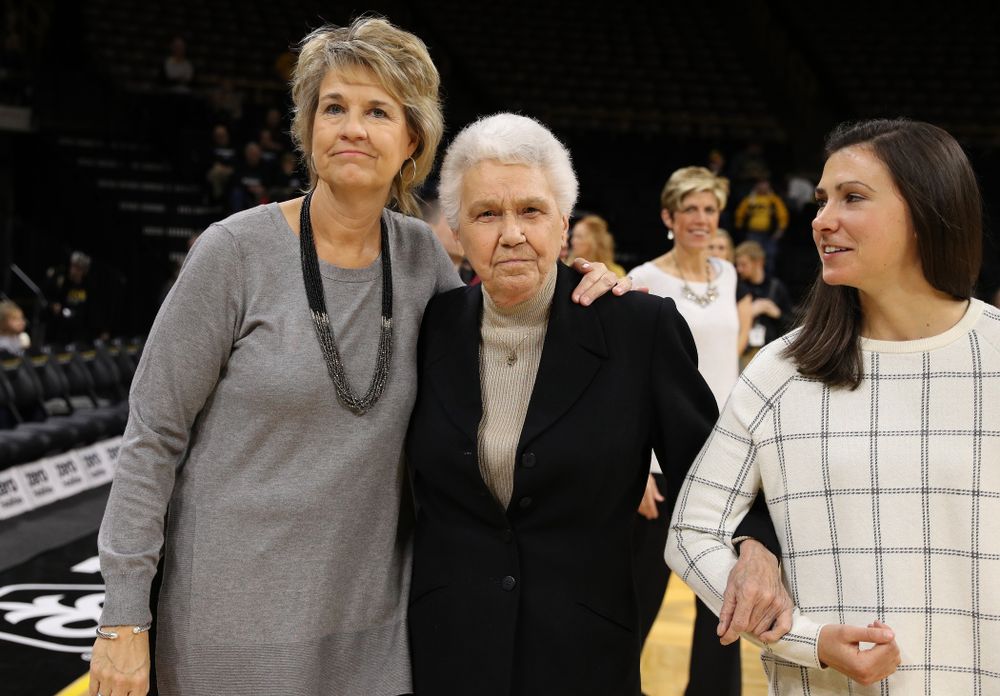 Former University of Iowa Director of Intercollegiate Athletics for Women Dr. Christine Grant receives her trophy for being inducted into the WomenÕs Basketball Hall of Fame from Iowa Hawkeyes head coach Lisa Bluder and director of basketball operations Kathryn Reynolds
before their game against the Robert Morris Colonials Sunday, December 2, 2018 at Carver-Hawkeye Arena. (Photo by Brian Ray)