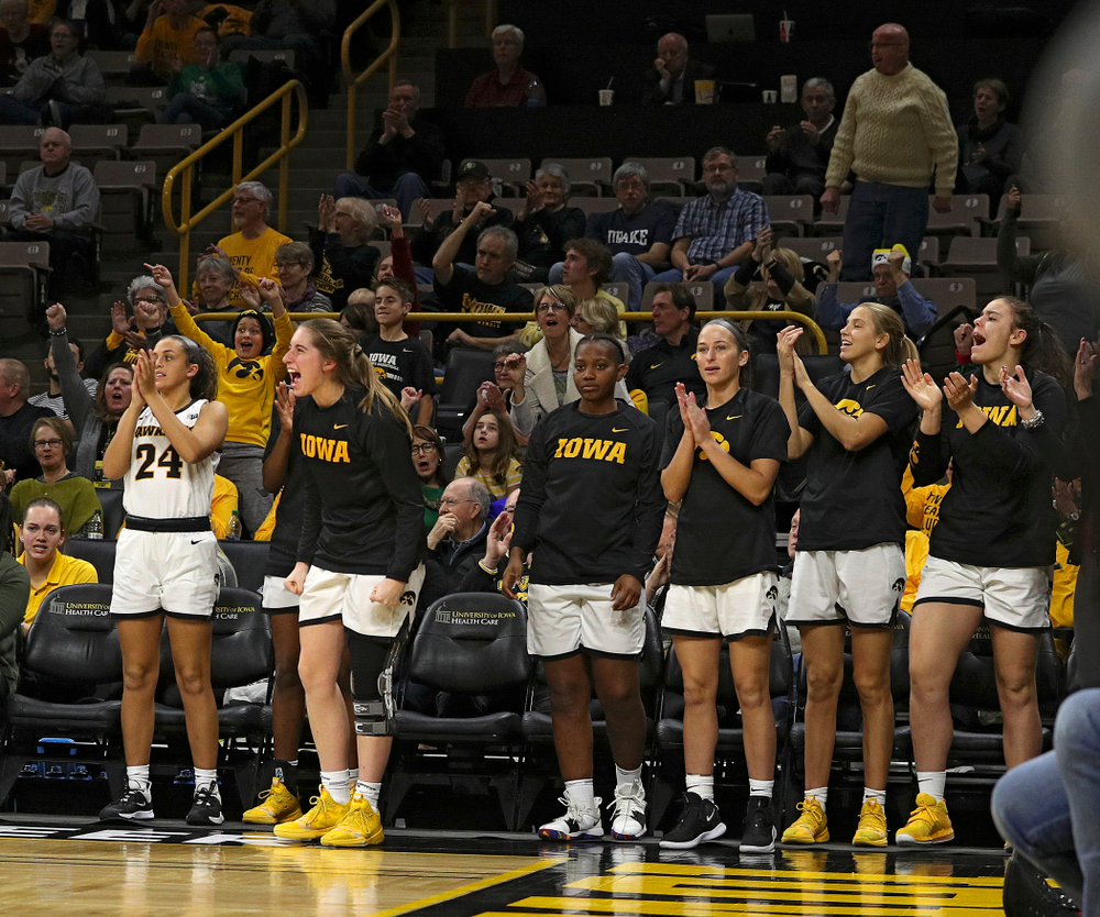 The Iowa bench cheers during the third quarter of their game at Carver-Hawkeye Arena in Iowa City on Saturday, December 21, 2019. (Stephen Mally/hawkeyesports.com)