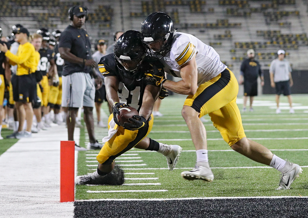Iowa Hawkeyes running back Ivory Kelly-Martin (21) dives for the pylon as he is hit by defensive back Wes Dvorak (1) during Fall Camp Practice No. 12 at Kinnick Stadium in Iowa City on Thursday, Aug 15, 2019. (Stephen Mally/hawkeyesports.com)