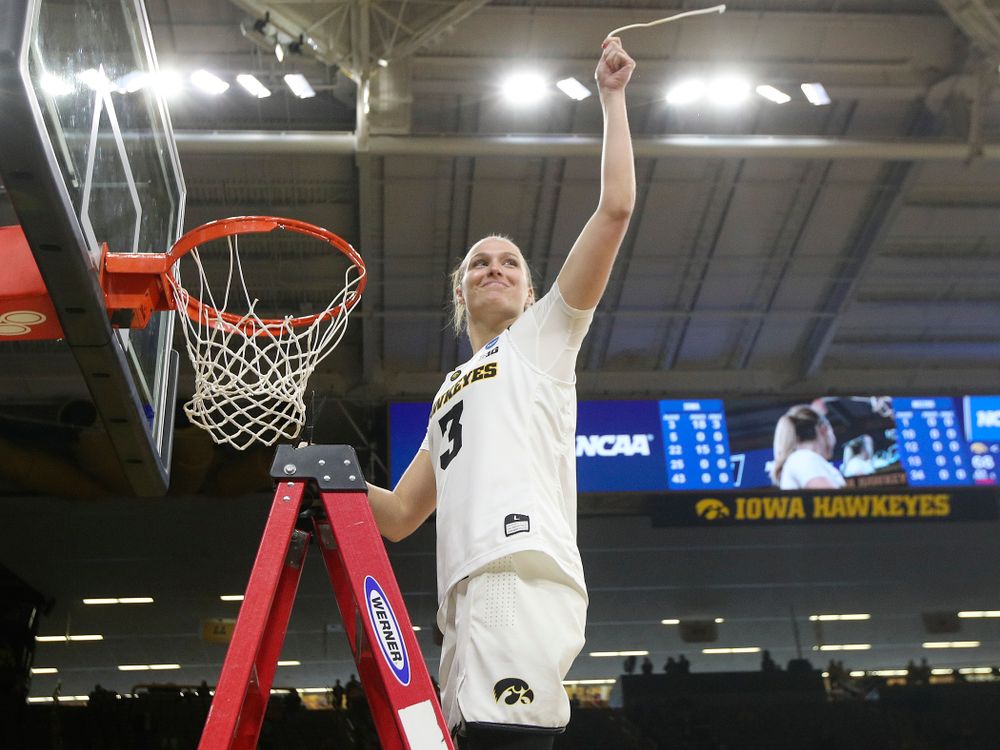 Iowa Hawkeyes guard Makenzie Meyer (3) cuts down the net after winning their second round game in the 2019 NCAA Women's Basketball Tournament at Carver Hawkeye Arena in Iowa City on Sunday, Mar. 24, 2019. (Stephen Mally for hawkeyesports.com)