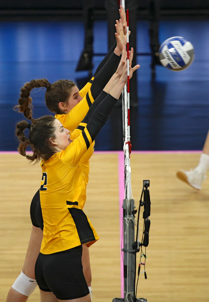 Iowa’s Blythe Rients (11) and Courtney Buzzerio (2) block a shot during their match at Carver-Hawkeye Arena in Iowa City on Sunday, Oct 20, 2019. (Stephen Mally/hawkeyesports.com)
