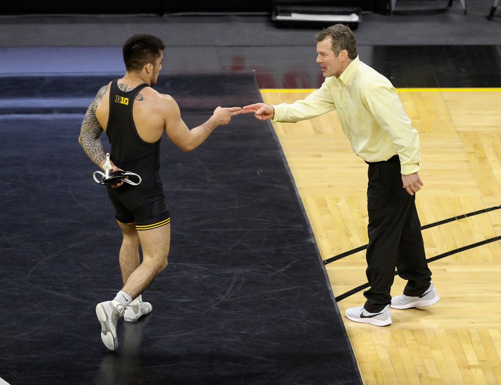 Iowa’s Pat Lugo (from left) celebrates his 6-1 win with head coach Tom Brands during their dual at Carver-Hawkeye Arena in Iowa City on Friday, January 31, 2020. (Stephen Mally/hawkeyesports.com)