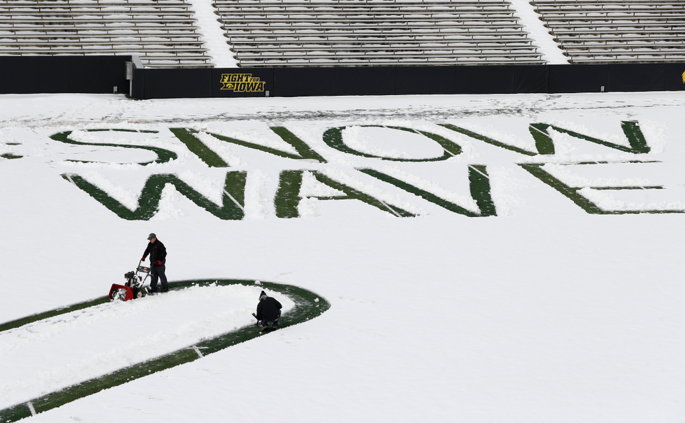 Members of the Iowa Athletics Turf Management staff create the #SnowWave for kids in the Stead Family Children's Hospital Thursday, February