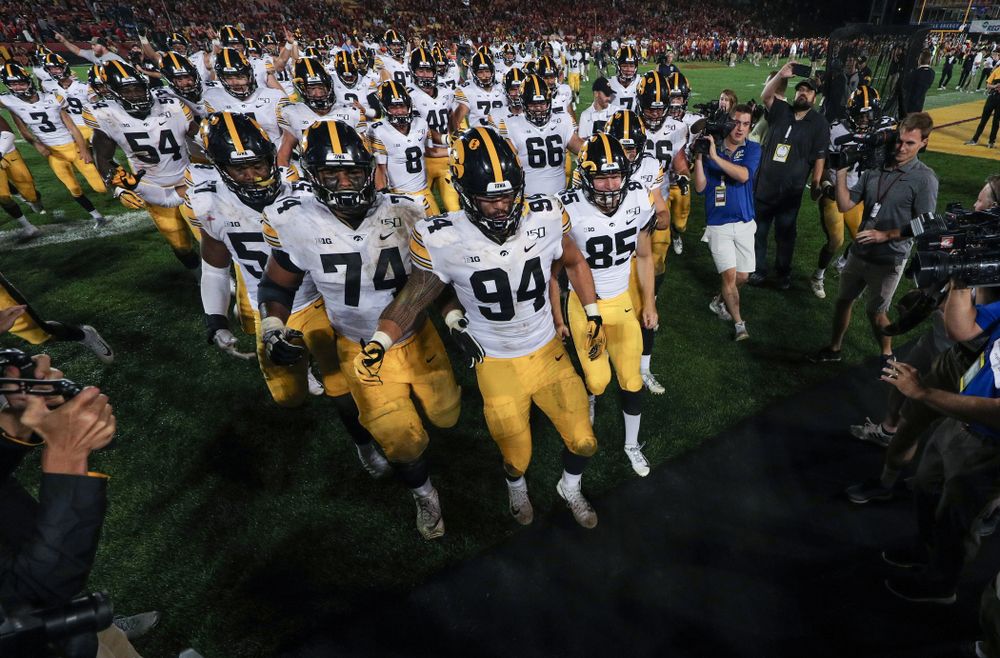 The Iowa Hawkeyes swarm to the Cy-Hawk trophy following their game against the Iowa State Cyclones Saturday, September 14, 2019 in Ames, Iowa. (Brian Ray/hawkeyesports.com)