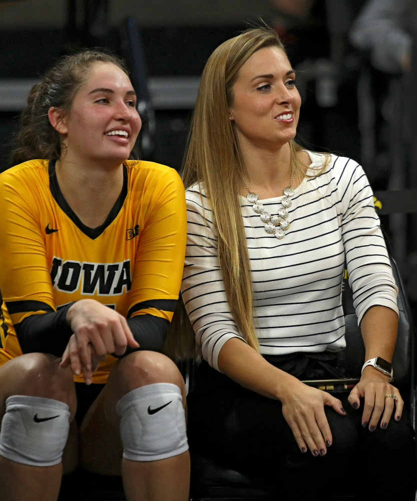 Iowa’s Blythe Rients (11) and Emily Sparks, director of operations, sit on the bench during their match at Carver-Hawkeye Arena in Iowa City on Sunday, Oct 20, 2019. (Stephen Mally/hawkeyesports.com)